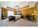 Bedroom with trey ceiling, ceiling fan, neutral carpet, natural light, and a desk at 5556 Cascade Sw Run, Atlanta, GA 30336
