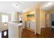 Hallway laundry area with washer, dryer, overhead shelving and hardwood flooring at 5556 Cascade Sw Run, Atlanta, GA 30336