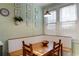 Bright dining area with a wooden table, built-in seating, and decorative botanical prints at 70 Sheridan Ne Dr # 10, Atlanta, GA 30305