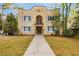 Inviting front exterior view of the apartment building with stucco and an arched balcony at 70 Sheridan Ne Dr # 10, Atlanta, GA 30305