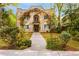Charming stucco home with lush landscaping and a welcoming floral archway over the entrance at 70 Sheridan Ne Dr # 10, Atlanta, GA 30305