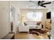 Cozy living room featuring a white sectional, hardwood floors, and a modern ceiling fan at 70 Sheridan Ne Dr # 10, Atlanta, GA 30305