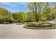Scenic street view of Historic Garden Hills with a roundabout and lush greenery on a sunny day at 70 Sheridan Ne Dr # 10, Atlanta, GA 30305