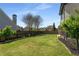 Large grassy backyard featuring a wooden fence and manicured landscaping at 341 Declaire Ne Way, Marietta, GA 30067