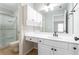 This bright and white bathroom offers a shower, white vanity, built-in medicine cabinet, and tile floor at 341 Declaire Ne Way, Marietta, GA 30067