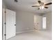 This bedroom offers a neutral color palette, carpet, ceiling fan, and open doorway to a bathroom at 341 Declaire Ne Way, Marietta, GA 30067