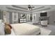 The staged primary bedroom offers carpet, sitting area with fireplace, and a trey ceiling with fan at 341 Declaire Ne Way, Marietta, GA 30067