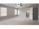 This light and airy bedroom features two windows, neutral colored carpet and walls, and a ceiling fan at 341 Declaire Ne Way, Marietta, GA 30067