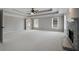 This bedroom features neutral walls, carpet, tray ceiling with fan, a stone fireplace and plenty of natural light at 341 Declaire Ne Way, Marietta, GA 30067