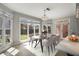 Bright breakfast nook features large windows overlooking the backyard and stylish chandelier at 341 Declaire Ne Way, Marietta, GA 30067