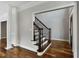 Open entryway features hardwood floors, elegant columns, and a staircase with dark metal spindles at 341 Declaire Ne Way, Marietta, GA 30067