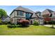 Elegant two-story home with a well-maintained lawn, two-car garage, and decorative shrubs at 341 Declaire Ne Way, Marietta, GA 30067