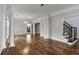 Bright living room featuring hardwood floors, decorative columns, and a chandelier, offering an open layout at 341 Declaire Ne Way, Marietta, GA 30067