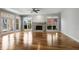Spacious living room with hardwood floors, a ceiling fan, and a cozy stone fireplace at 341 Declaire Ne Way, Marietta, GA 30067