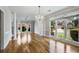 Bright living room featuring hardwood floors, large windows, and a crystal chandelier at 341 Declaire Ne Way, Marietta, GA 30067
