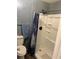Bathroom with toilet and shower and blue curtain at 3518 Shepherds Path, Decatur, GA 30034