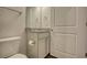 Compact bathroom featuring a toilet, vanity with a granite countertop, and a towel rack at 711 Park Place Way, Social Circle, GA 30025