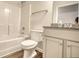 Clean, bright bathroom featuring a shower-tub combo, toilet, and granite vanity at 711 Park Place Way, Social Circle, GA 30025