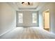 Spacious bedroom featuring tray ceiling, neutral paint, carpet, and two windows at 711 Park Place Way, Social Circle, GA 30025