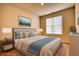 Comfortable bedroom with a plush bed, nightstands, decor, and a large window for natural light at 711 Park Place Way, Social Circle, GA 30025