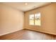 Bright bedroom featuring a window and modern flooring for comfortable living at 711 Park Place Way, Social Circle, GA 30025