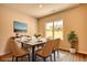 Bright dining room with a table for six, elegant decor, and a large window for natural light at 711 Park Place Way, Social Circle, GA 30025