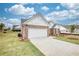 Charming single-story brick home with a well-manicured lawn and a two-car garage at 711 Park Place Way, Social Circle, GA 30025