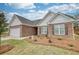 Beautiful exterior of a brick home with a garage and landscaped front yard at 711 Park Place Way, Social Circle, GA 30025