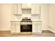 Kitchen features modern stainless steel appliances, white cabinets and granite countertop at 711 Park Place Way, Social Circle, GA 30025