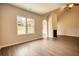 Living area featuring fireplace, high ceiling and a large window overlooking backyard at 711 Park Place Way, Social Circle, GA 30025