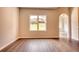 Spacious living room with window, archway and attractive wood-look flooring at 711 Park Place Way, Social Circle, GA 30025