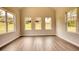 Bright living room boasting laminate floors, trim work, and an array of windows providing plenty of light at 711 Park Place Way, Social Circle, GA 30025