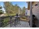 Outdoor deck area offers a relaxing space for outdoor dining, complete with a grill and natural scenery at 8385 E Village School E Dr, Cumming, GA 30041