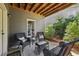 Comfortable back patio with seating, a small table, and access to green space, perfect for outdoor relaxation at 8385 E Village School E Dr, Cumming, GA 30041