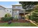 The backyard features a deck, a walkout basement, mature landscaping, and a fire pit seating area at 8385 E Village School E Dr, Cumming, GA 30041