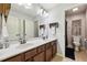 Bathroom featuring double sinks, a large mirror, and access to a private toilet room at 8385 E Village School E Dr, Cumming, GA 30041
