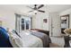 Bright bedroom with a ceiling fan, window, walk-in closet providing lots of space at 8385 E Village School E Dr, Cumming, GA 30041