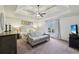 Bedroom with a tray ceiling, sitting area, neutral decor, and a window view at 8385 E Village School E Dr, Cumming, GA 30041