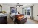 Cozy bedroom with a ceiling fan, natural light, and stylish decor creates a relaxing retreat at 8385 E Village School E Dr, Cumming, GA 30041
