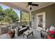 Relaxing covered deck features stylish furniture and green surroundings at 8385 E Village School E Dr, Cumming, GA 30041