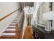 Bright entryway with hardwood floors, staircase, and decorative furnishings at 8385 E Village School E Dr, Cumming, GA 30041