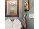 Charming half bathroom with stylish mirror and vanity at 8385 E Village School E Dr, Cumming, GA 30041