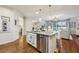 Bright kitchen with stainless steel appliances, granite countertops, and an open layout to the living room at 8385 E Village School E Dr, Cumming, GA 30041