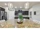 Charming kitchen with stainless steel appliances, granite countertops and dark wood cabinets at 8385 E Village School E Dr, Cumming, GA 30041