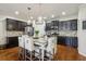 Charming kitchen features a center island with granite countertops and stainless steel appliances at 8385 E Village School E Dr, Cumming, GA 30041