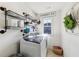 Well-organized laundry room with modern washer/dryer, shelving, and decorative accents at 8385 E Village School E Dr, Cumming, GA 30041