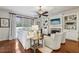 Bright living room with hardwood floors, built-in shelving, a cozy fireplace, and comfortable seating at 8385 E Village School E Dr, Cumming, GA 30041