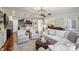 Inviting living room featuring hardwood floors, comfortable seating, and a view into the dining area at 8385 E Village School E Dr, Cumming, GA 30041