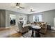 Spacious living room with ceiling fans, cozy seating, and natural light at 8385 E Village School E Dr, Cumming, GA 30041
