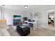 A carpeted bonus room with a TV, desk, and seating area in a neutral color palette at 8385 E Village School E Dr, Cumming, GA 30041
